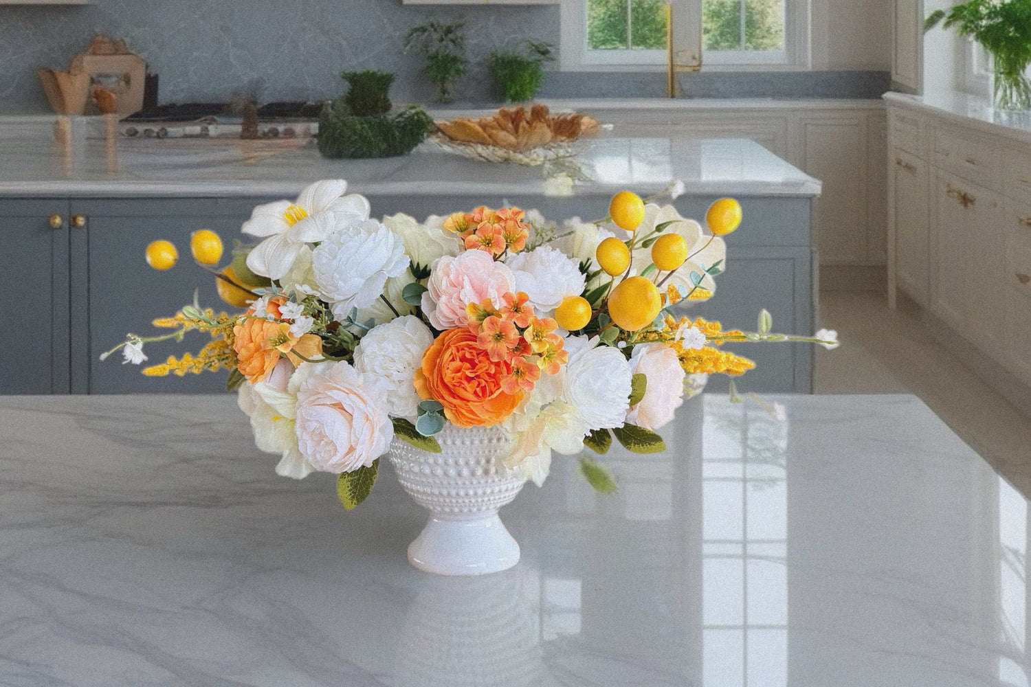 Elegant artificial flower arrangement in a white vase with a mix of white roses, peonies, and delicate orange blossoms accented with bright yellow details. This timeless centerpiece is perfect for year-round home decor, dining table decoration, or as a cheerful gift. Handmade from high-quality faux flowers, it looks realistic, stays fresh all year long, and requires no maintenance. A lovely accent for farmhouse, rustic, or modern interiors.