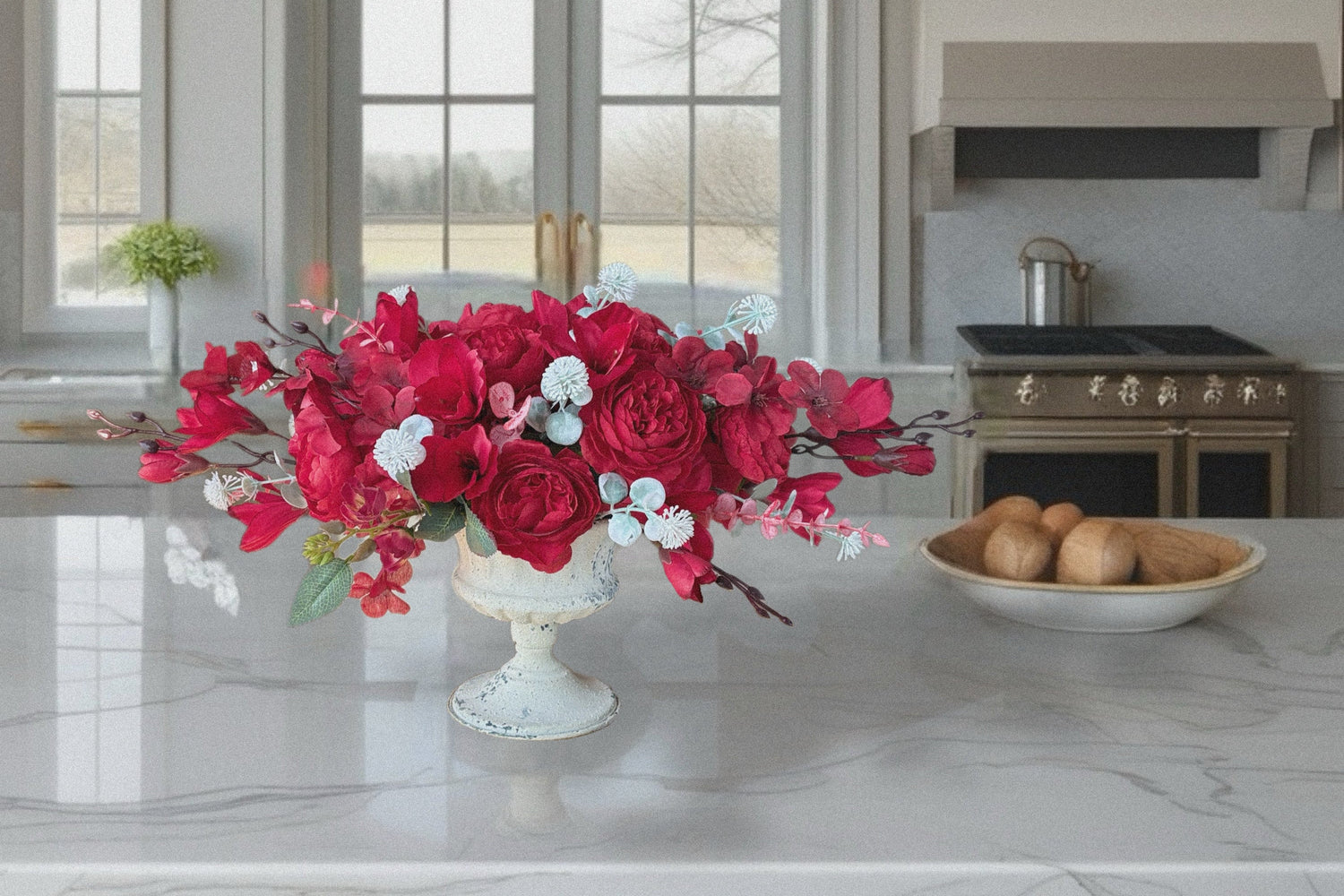 Kitchen with a floral arrangement on the counter and a gold pendant light.