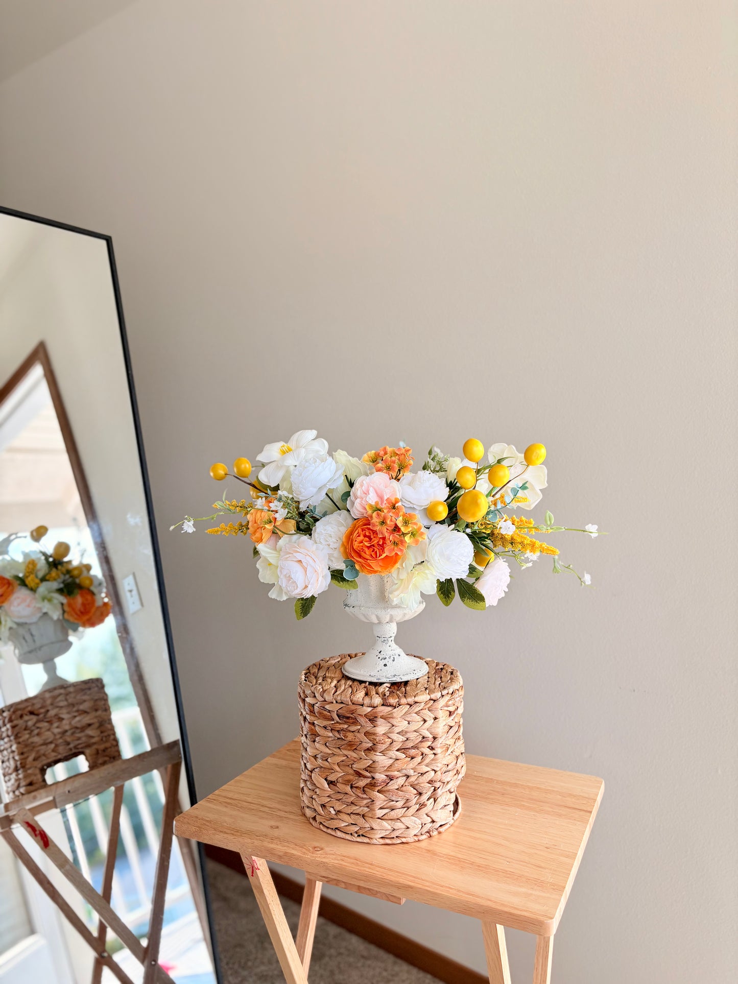 Floral arrangement on a woven table with a neutral background