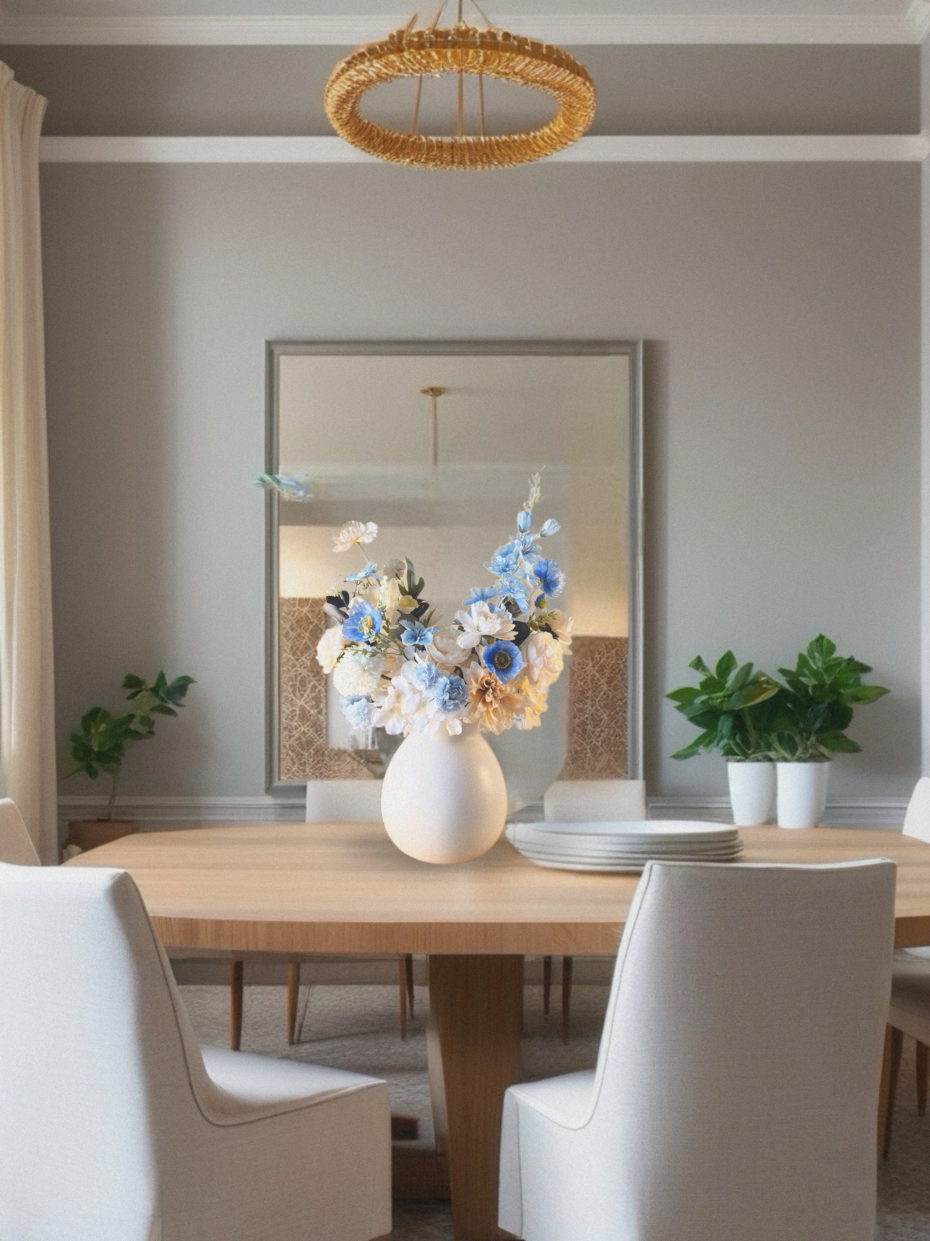 Dining room with a wooden table, white chairs, and a vase of flowers.
