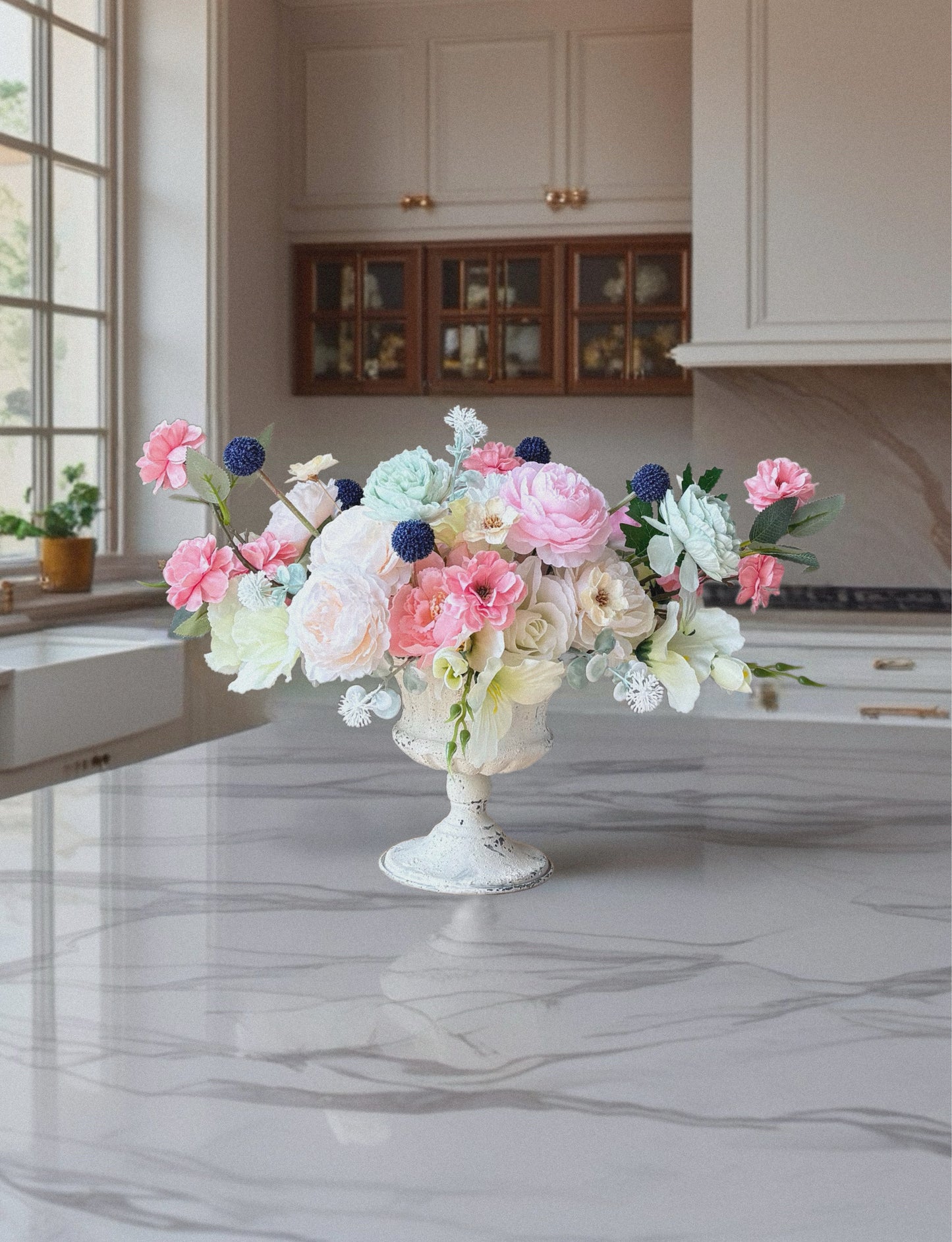Floral arrangement in a decorative vase on a kitchen counter
