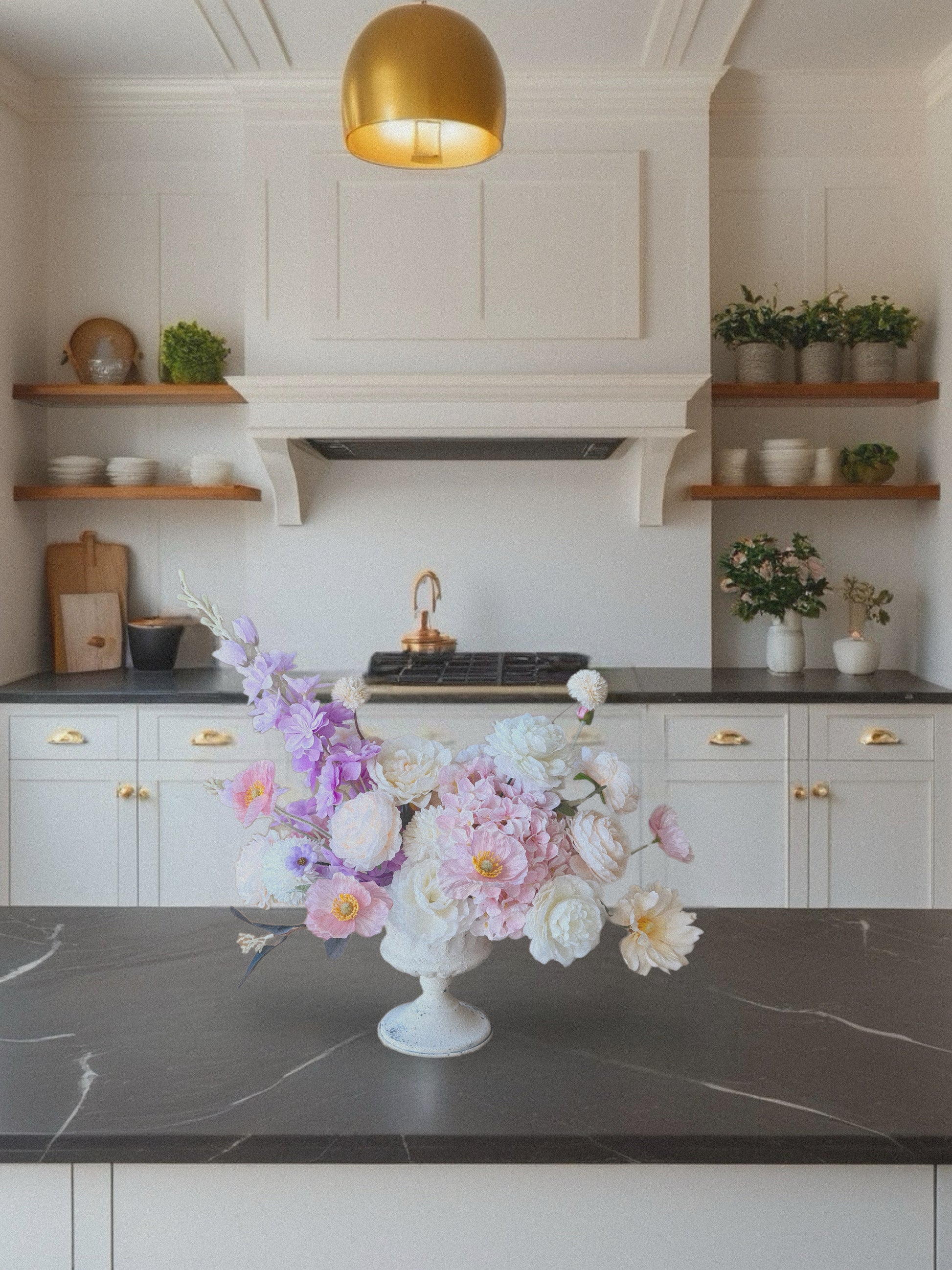 Kitchen with a decorative floral arrangement on a dark countertop