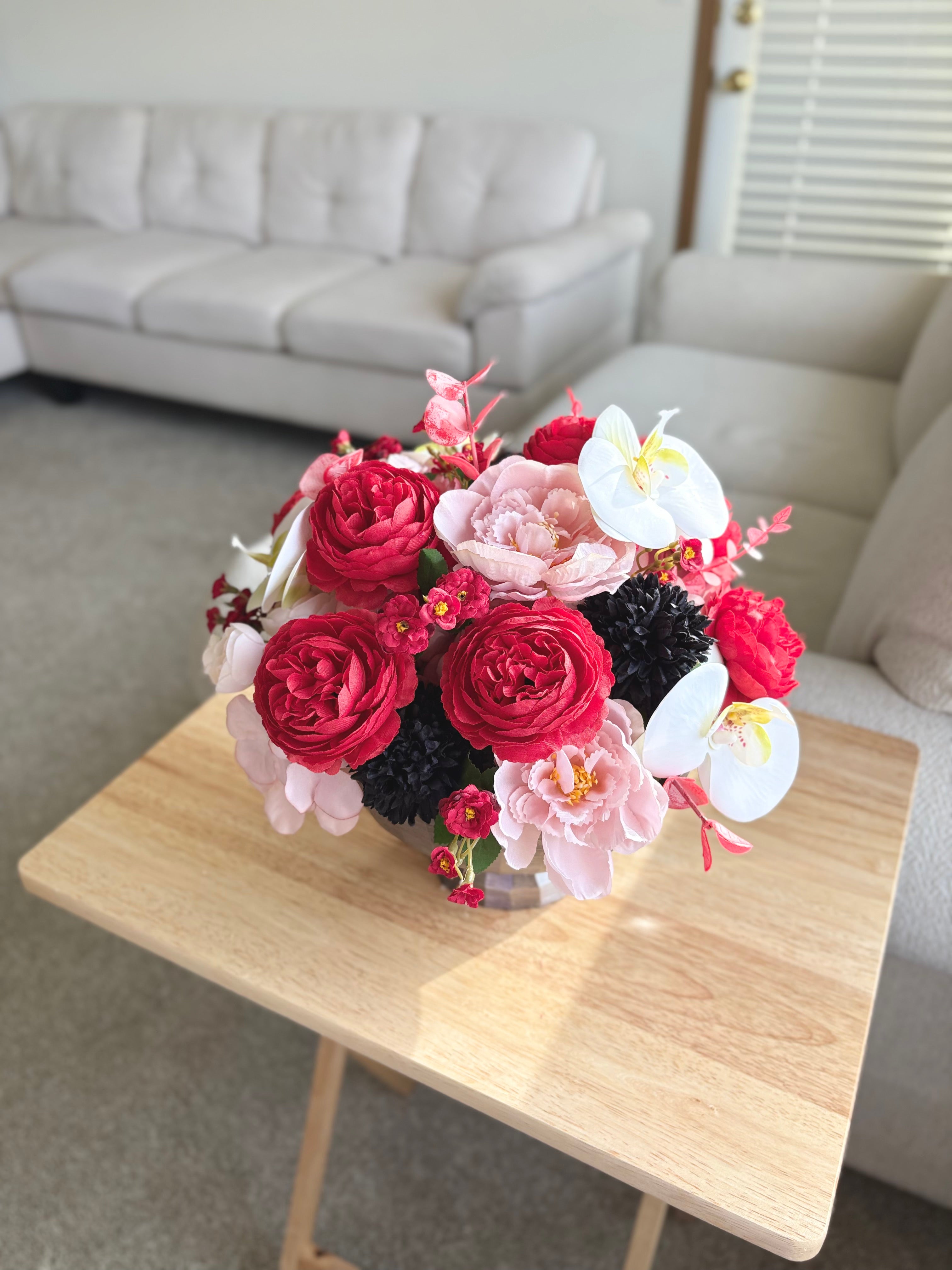 Bouquet of flowers on a wooden table in a living room setting