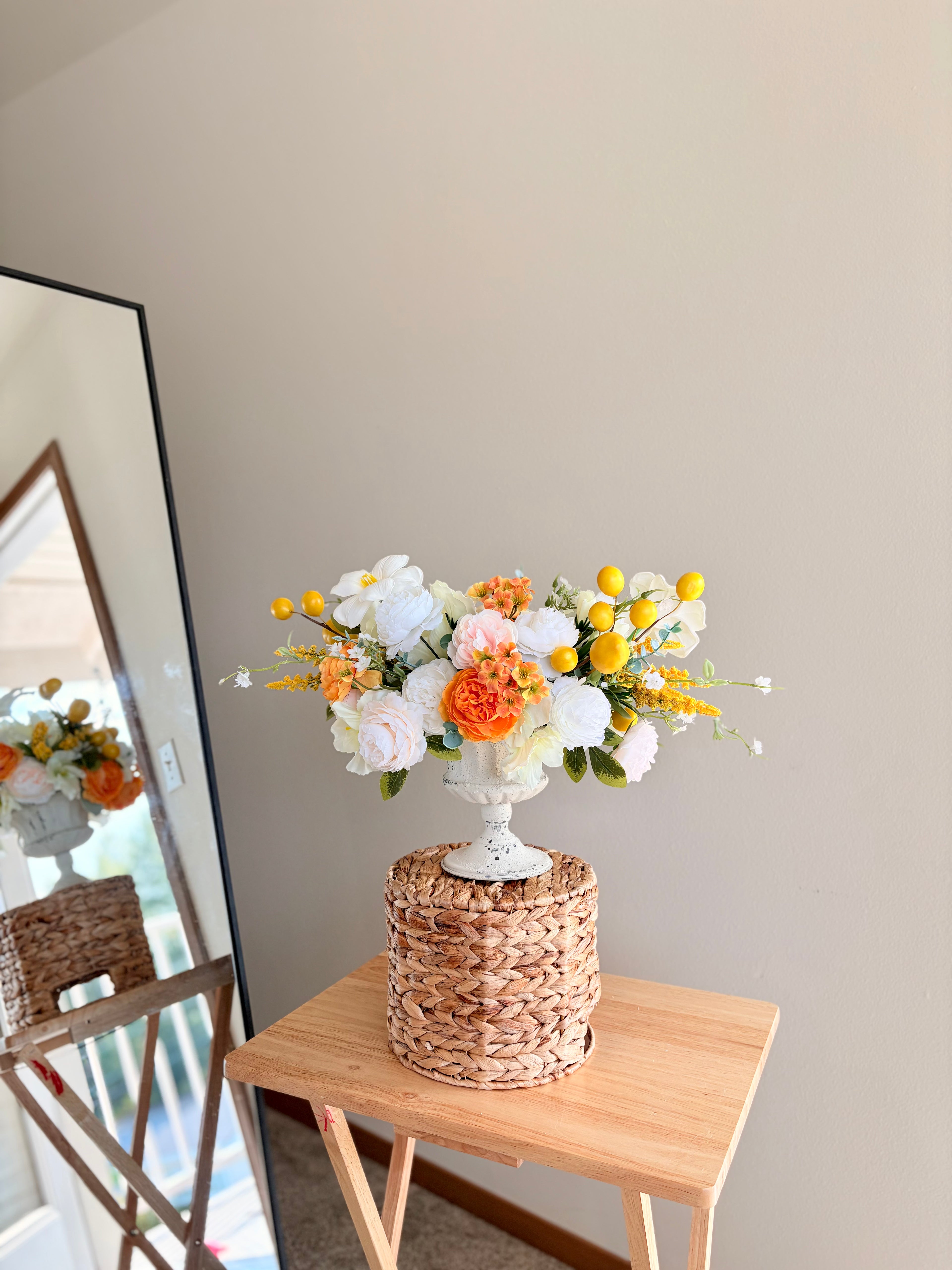 Floral arrangement on a woven table with a neutral background