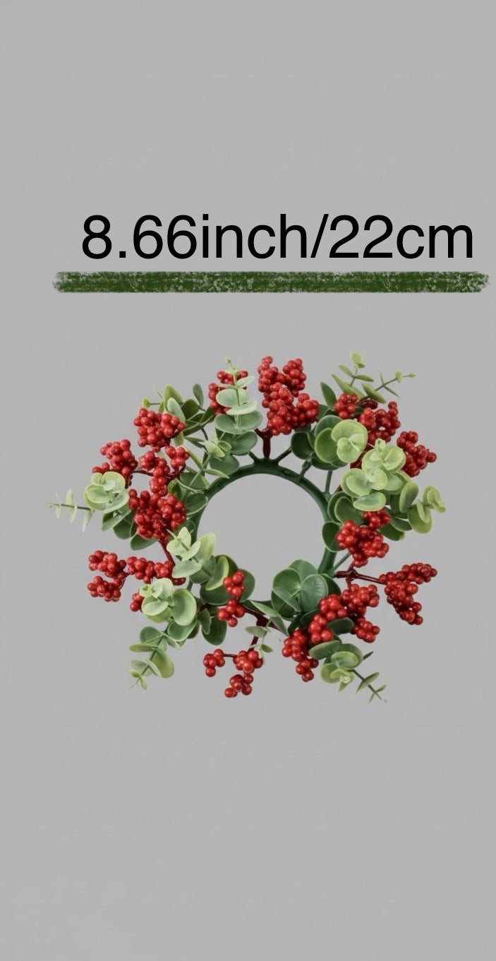 Small wreath with red berries and green leaves on a gray background with measurement text.