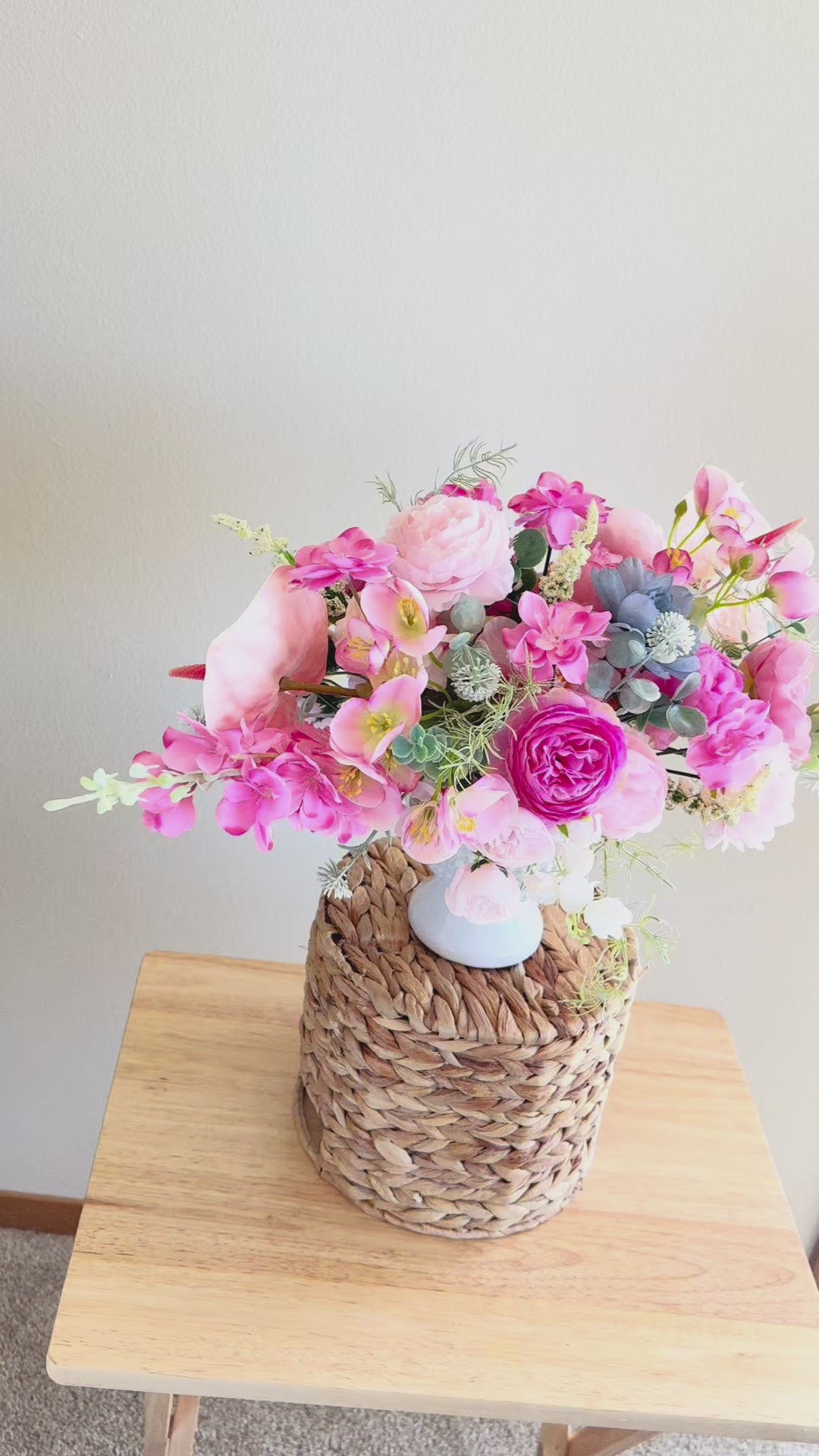 Pink romantic style bouquet with peonies and roses in a ceramic vase